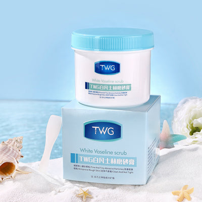 TWG White Vaseline scrub jar and box on a beach-themed background, showcasing a skincare product for exfoliation.